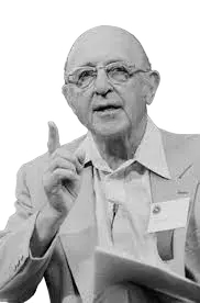 "Carl Rogers, psicólogo humanista, con traje gris"